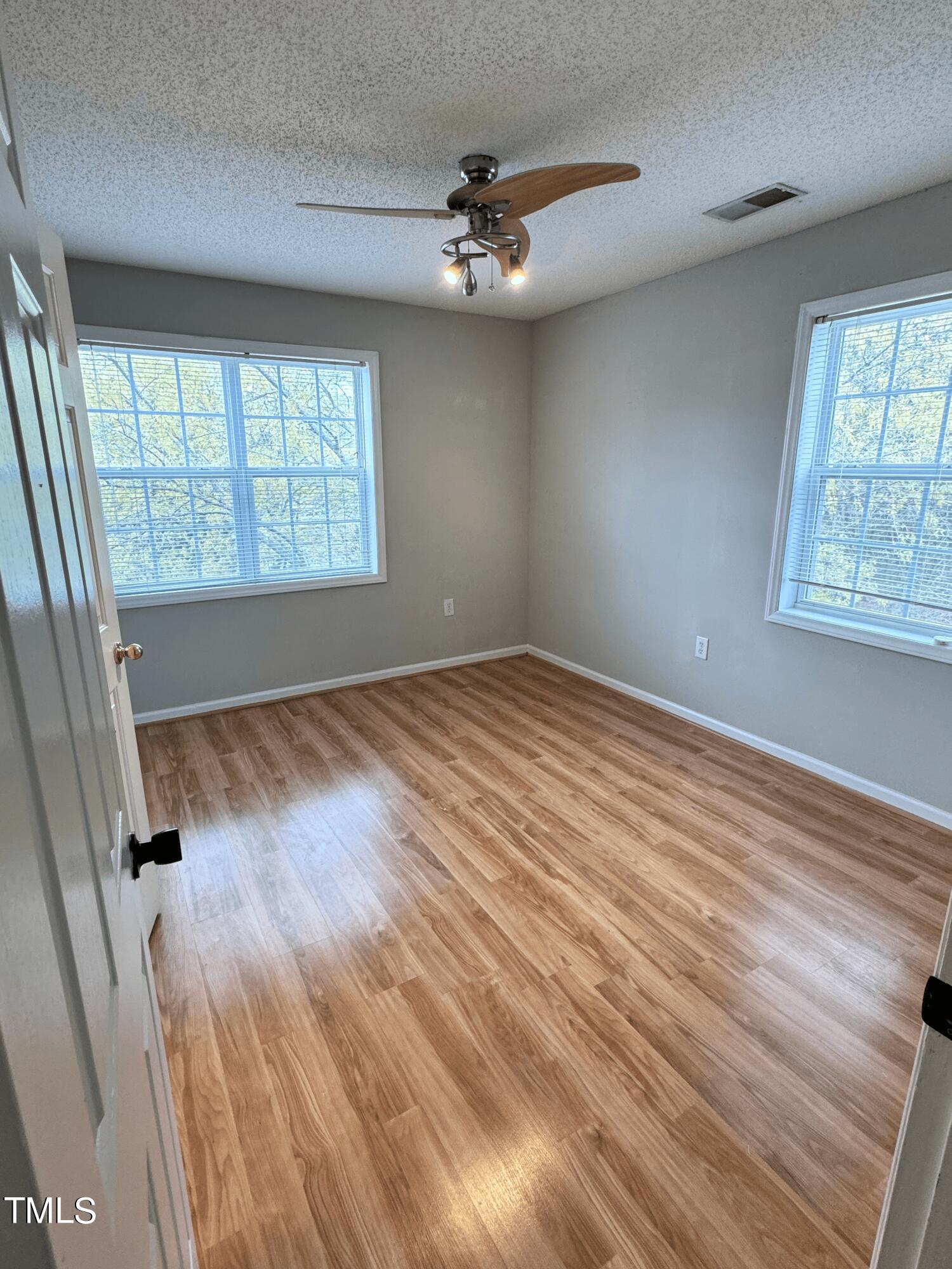 2011 Wolfmill Drive, Unit 301 Raleigh, NC 27603 - Photo 5 of 6 a view of an empty room with a window and wooden floor