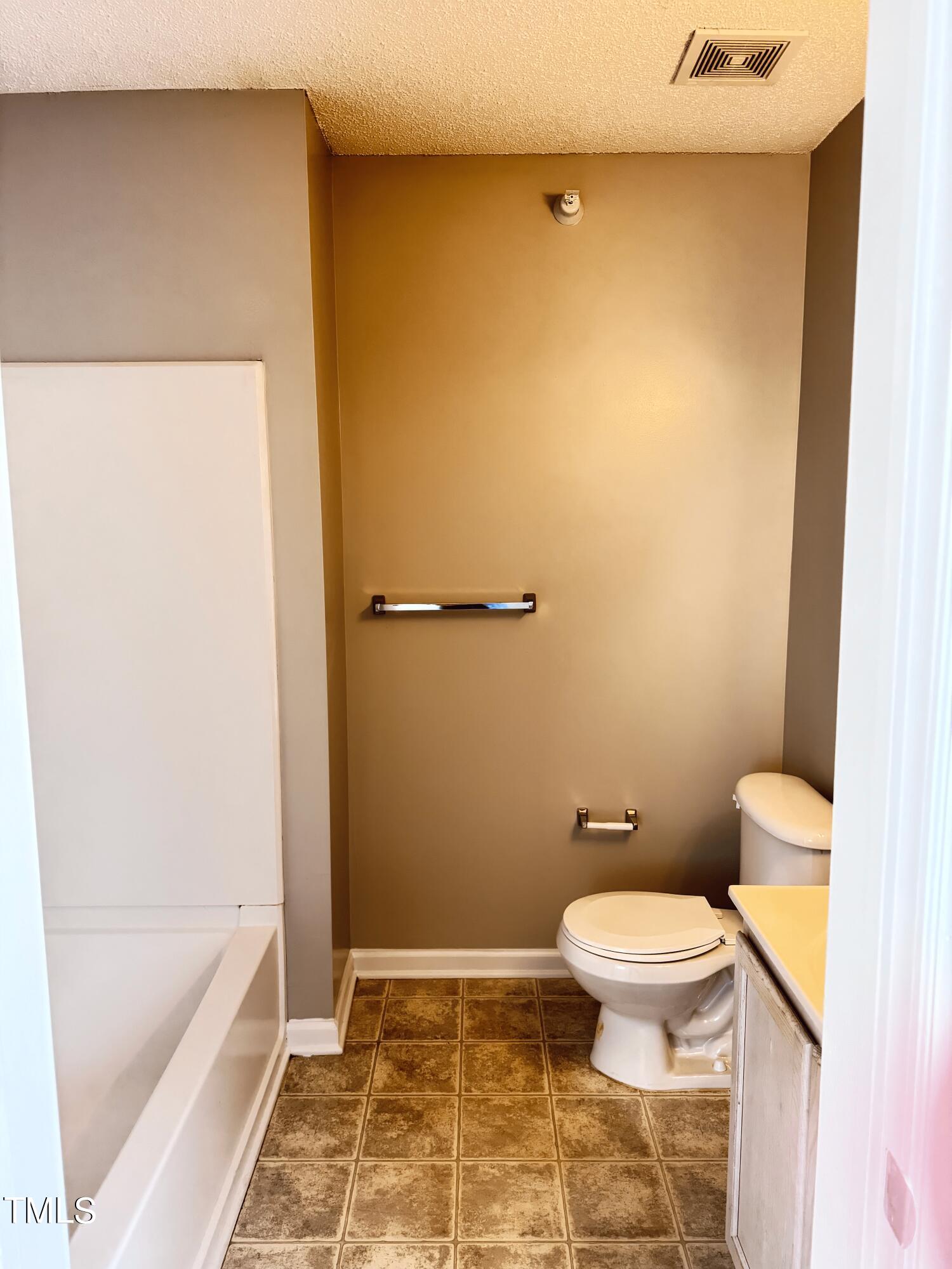 2011 Wolfmill Drive, Unit 301 Raleigh, NC 27603 - Photo 6 of 6 a bathroom with a toilet and a bathtub