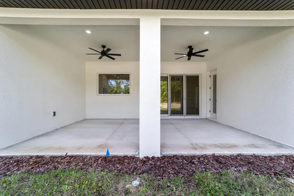a large white kitchen with granite countertop a large counter top stainless steel appliances and cabinets