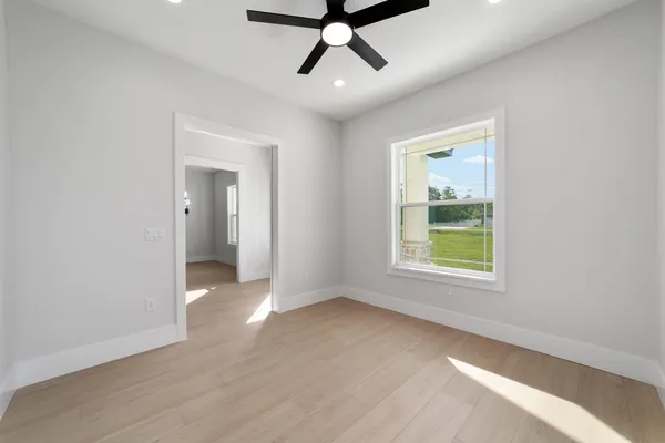 a view of an empty room with a ceiling fan