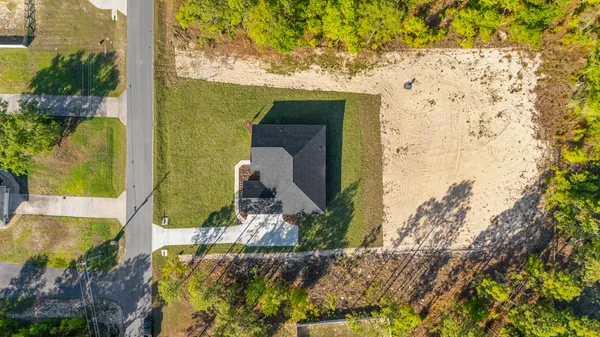 a view of a house with backyard and porch