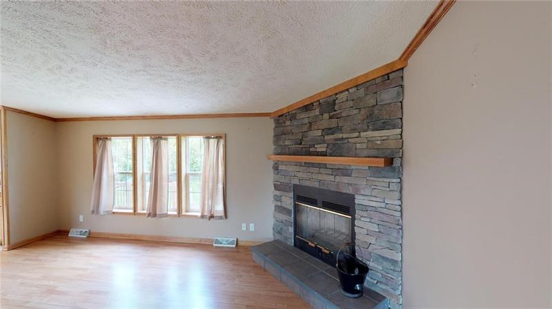 346 Hutchman Road Mars, PA 16046 - Photo 16 of 25 Enjoy Chilly Nights in the Large Family Room in Front of the Wood Burning Fireplace! Large Window Overlooks Private Backyard and Brings in so much Natural Light! Beautiful Wood Flooring!