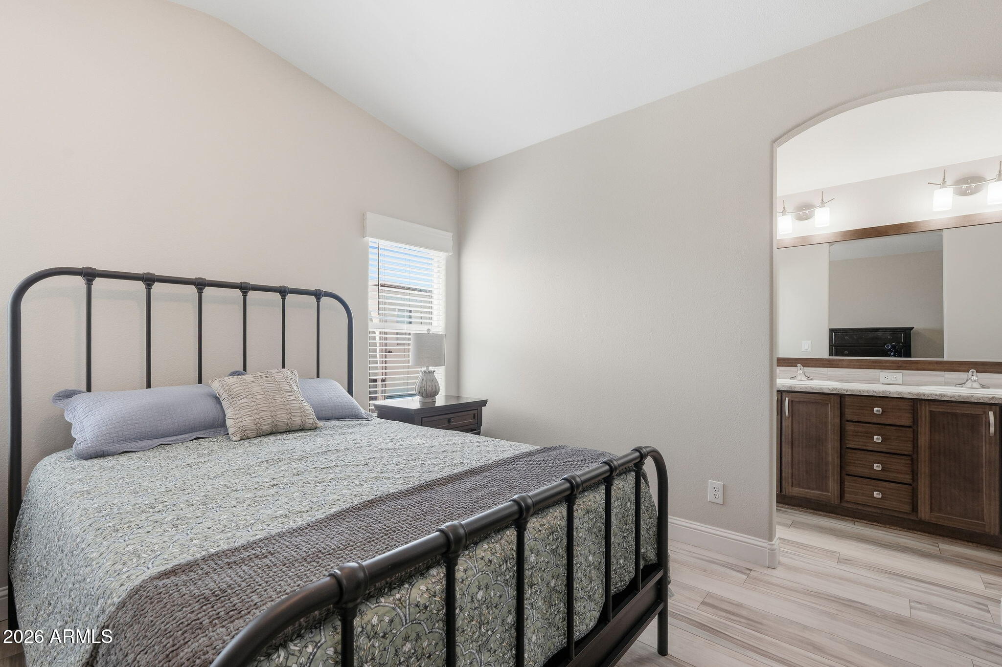 8865 East Baseline Road, Unit 1417 Mesa, AZ 85209 - Photo 17 of 47 a bedroom with a bed and wooden floor