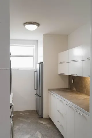 a kitchen with a refrigerator and microwave