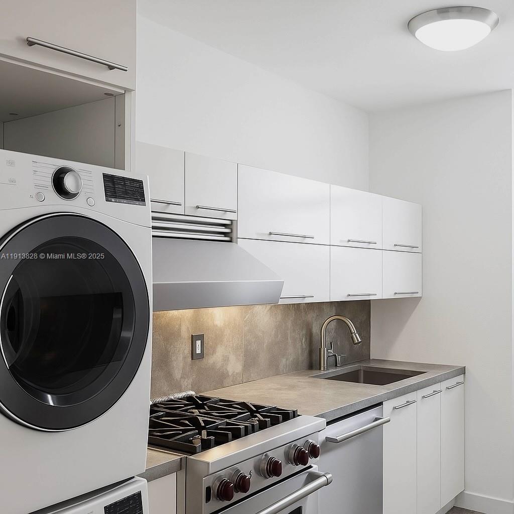 1300 Lincoln Road, Unit A301 Miami Beach, FL 33139 - Photo 5 of 13 a kitchen with a stove and a microwave