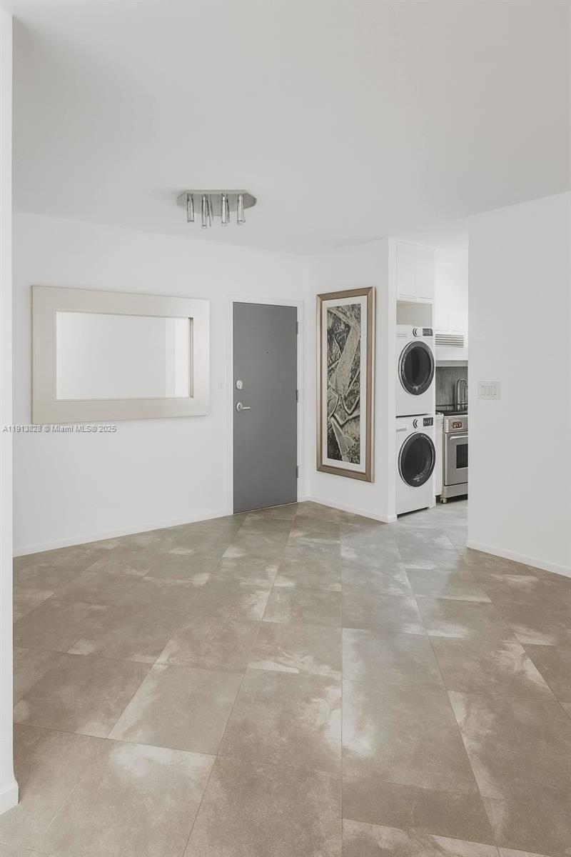 1300 Lincoln Road, Unit A301 Miami Beach, FL 33139 - Photo 6 of 13 a view of an empty room with window and chandelier