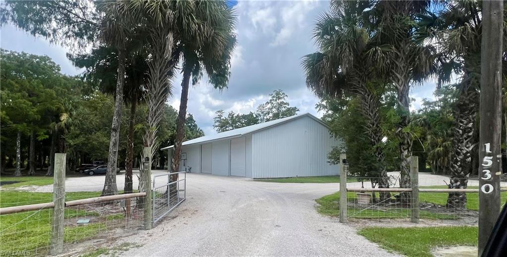 1303 Shady Lane Naples, FL 34120 - Photo 2 of 4 a front view of a house with garden