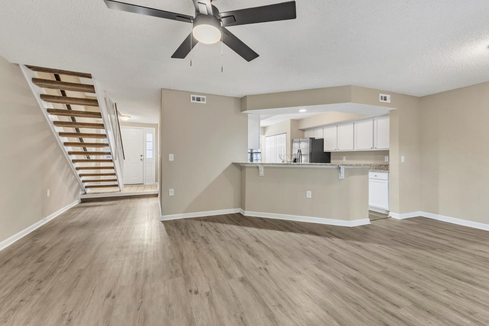 2430 Condor Court Raleigh, NC 27615 - Photo 11 of 34 an empty room with wooden floor kitchen view and a window