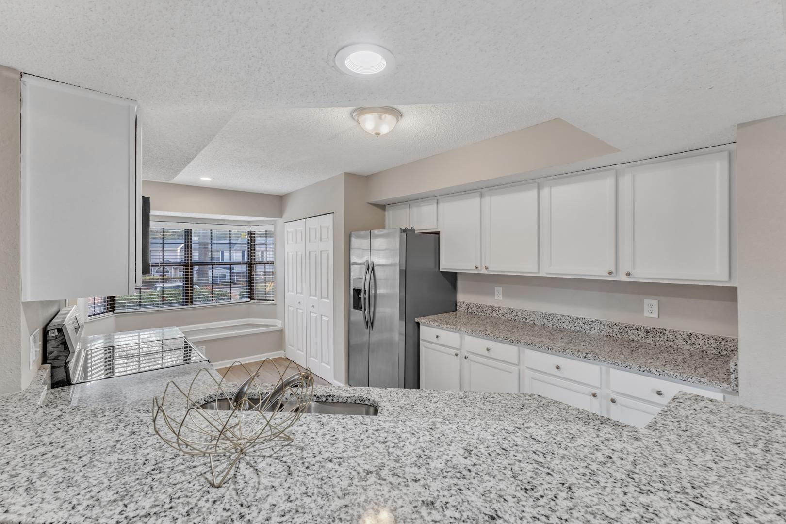 2430 Condor Court Raleigh, NC 27615 - Photo 15 of 34 a kitchen with stainless steel appliances kitchen island granite countertop a refrigerator and cabinets