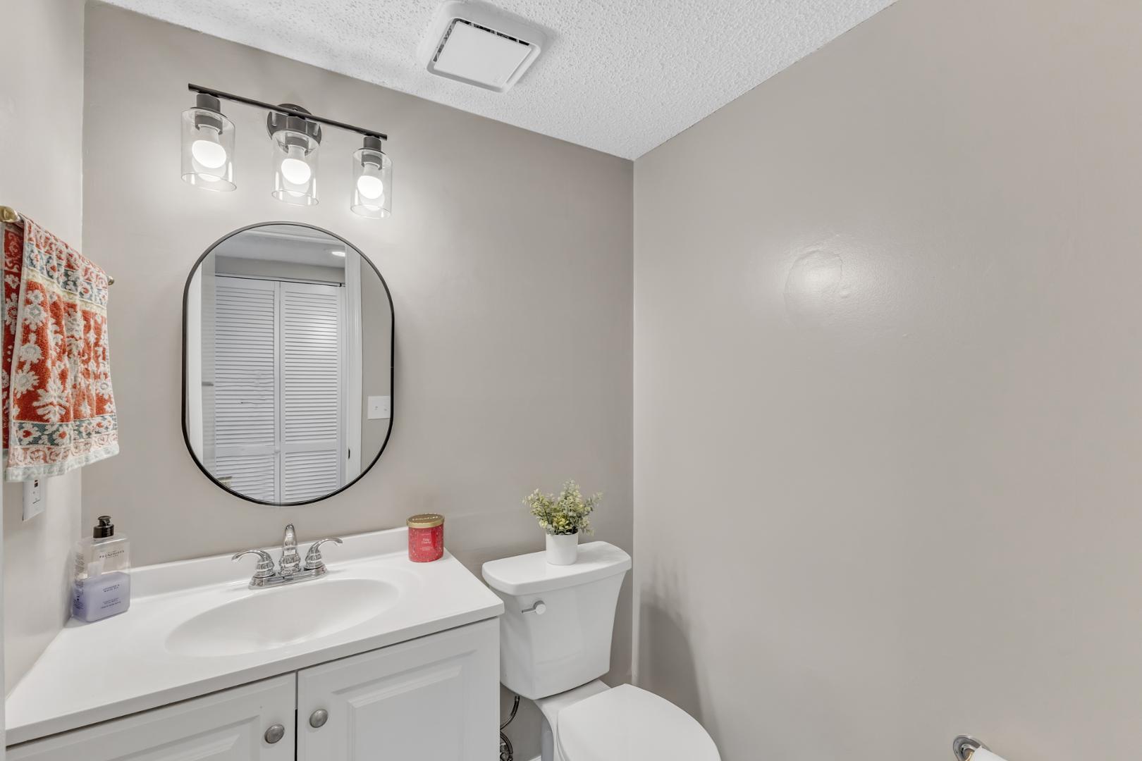 2430 Condor Court Raleigh, NC 27615 - Photo 16 of 34 a bathroom with a toilet sink and mirror