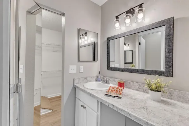an empty room with closet and a chandelier fan