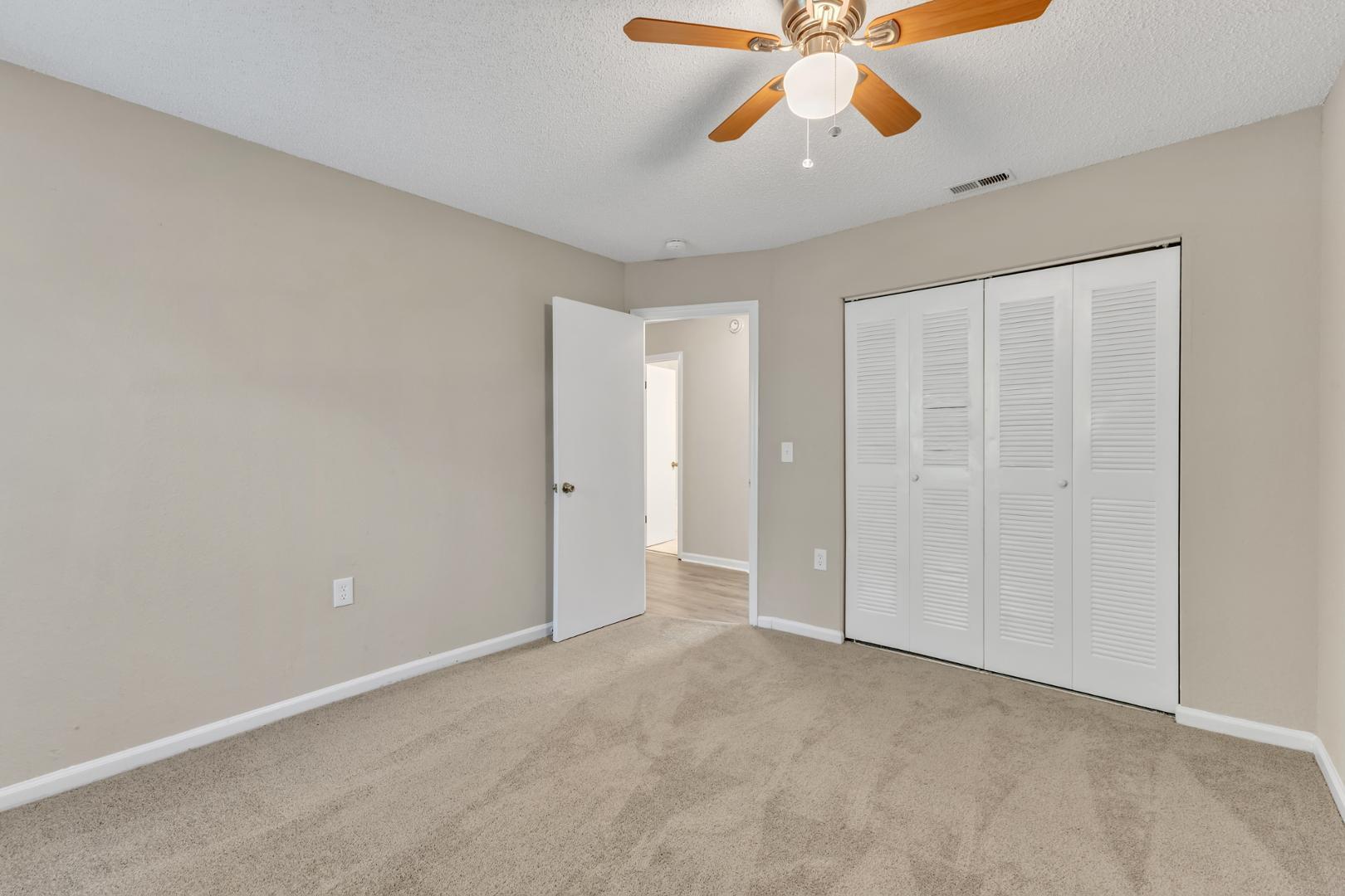 2430 Condor Court Raleigh, NC 27615 - Photo 24 of 34 an empty room with chandelier fan and windows