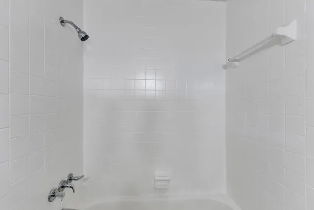 a view of house with window and potted plants in front of door