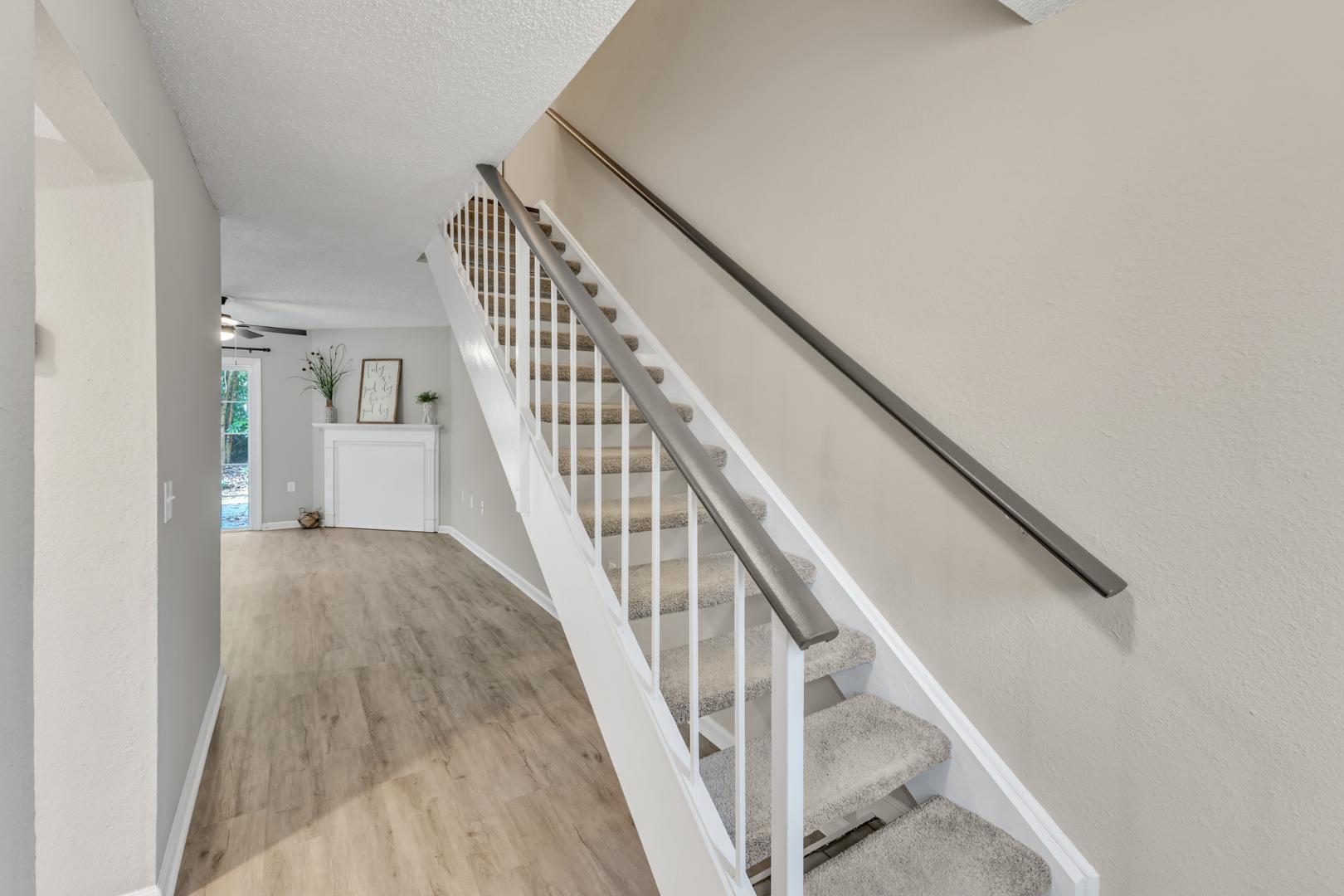2430 Condor Court Raleigh, NC 27615 - Photo 4 of 34 a view of staircase with wooden floor and white walls