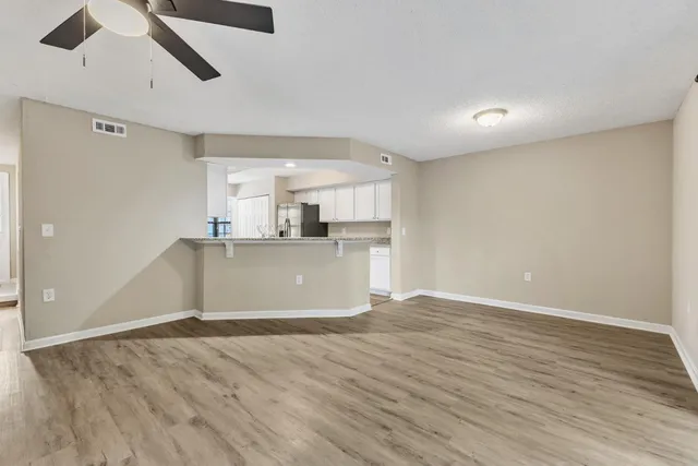a view of a kitchen with a dishwasher and wooden floor