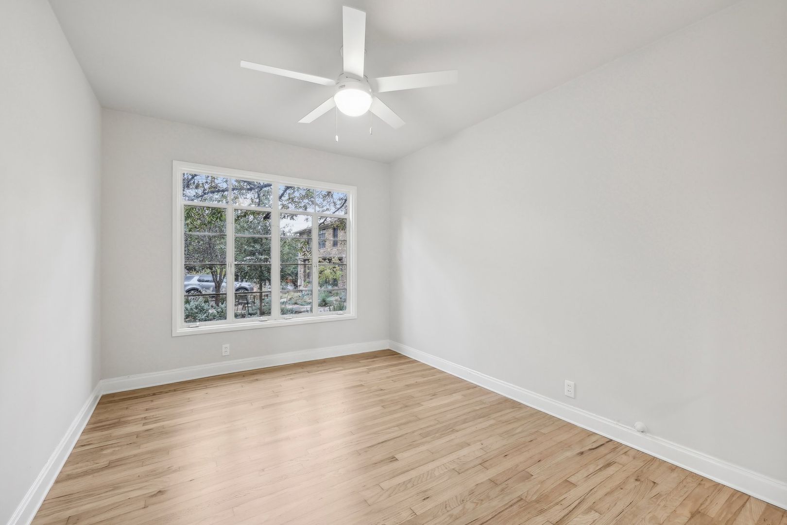 3010 Windsor Road, Unit E Austin, TX 78703 - Photo 14 of 21 an empty room with wooden floor and windows