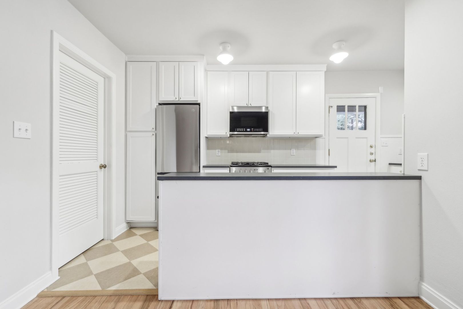 3010 Windsor Road, Unit E Austin, TX 78703 - Photo 7 of 21 a kitchen with stainless steel appliances granite countertop a refrigerator and a stove top oven