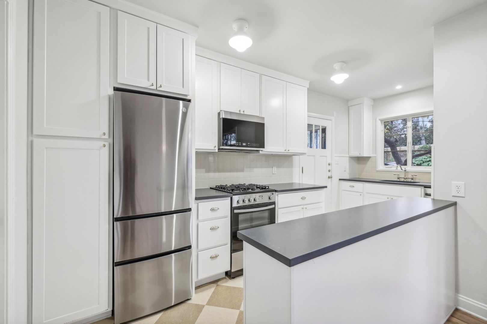 3010 Windsor Road, Unit E Austin, TX 78703 - Photo 8 of 21 a kitchen with appliances a refrigerator and a sink