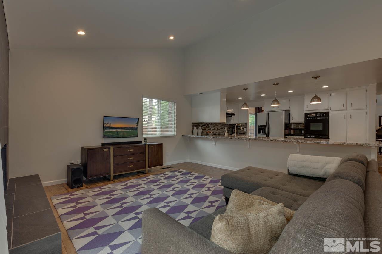 960 Twin Pines Road Reno, NV 89509 - Photo 12 of 26 a living room with furniture and a flat screen tv
