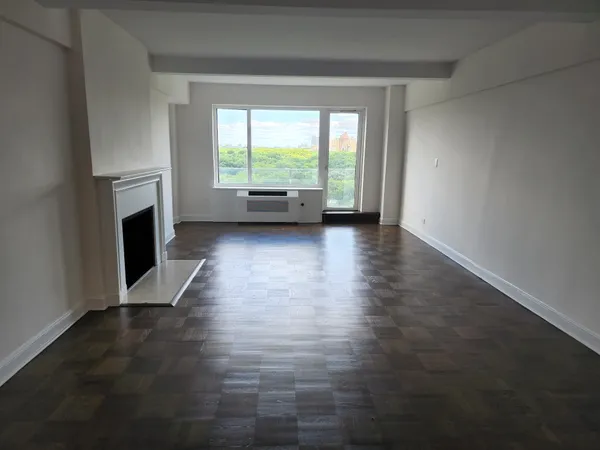 wooden floor in an empty room with a fireplace