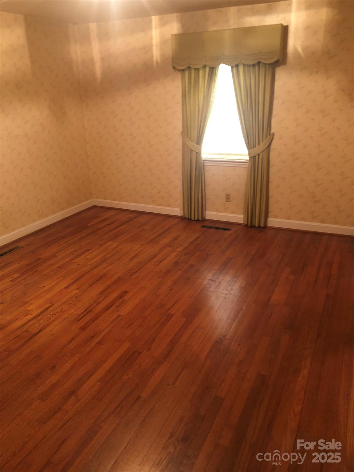 1575 Highway 220 Biscoe, NC 27209 - Photo 14 of 17 an empty room with wooden floor and windows