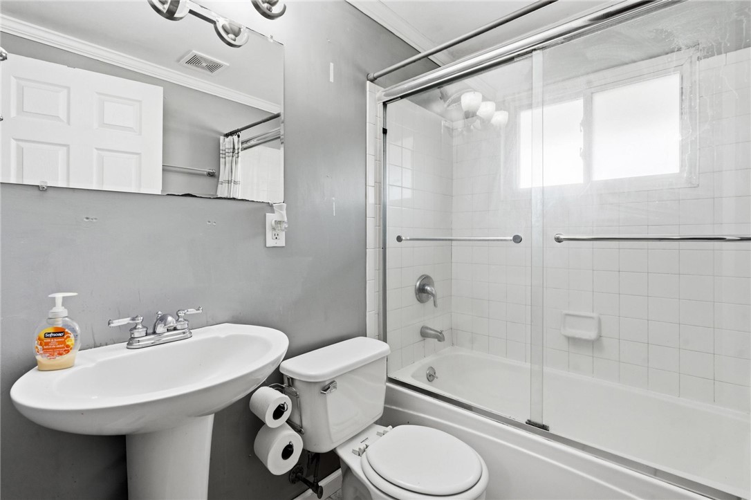 3890 Endover Road Dayton, OH 45439 - Photo 19 of 26 This bright bathroom features a pedestal sink and a shower-tub combination with tile surround.