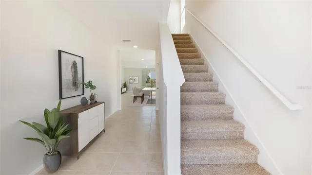 a view of staircase with white walls and frames on wall
