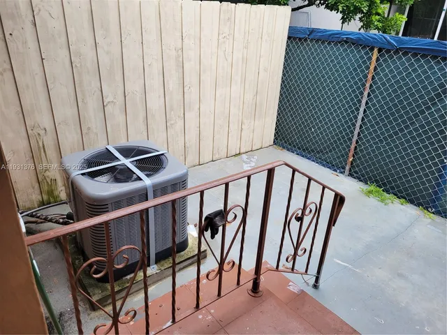 a large kitchen with a refrigerator and a sink