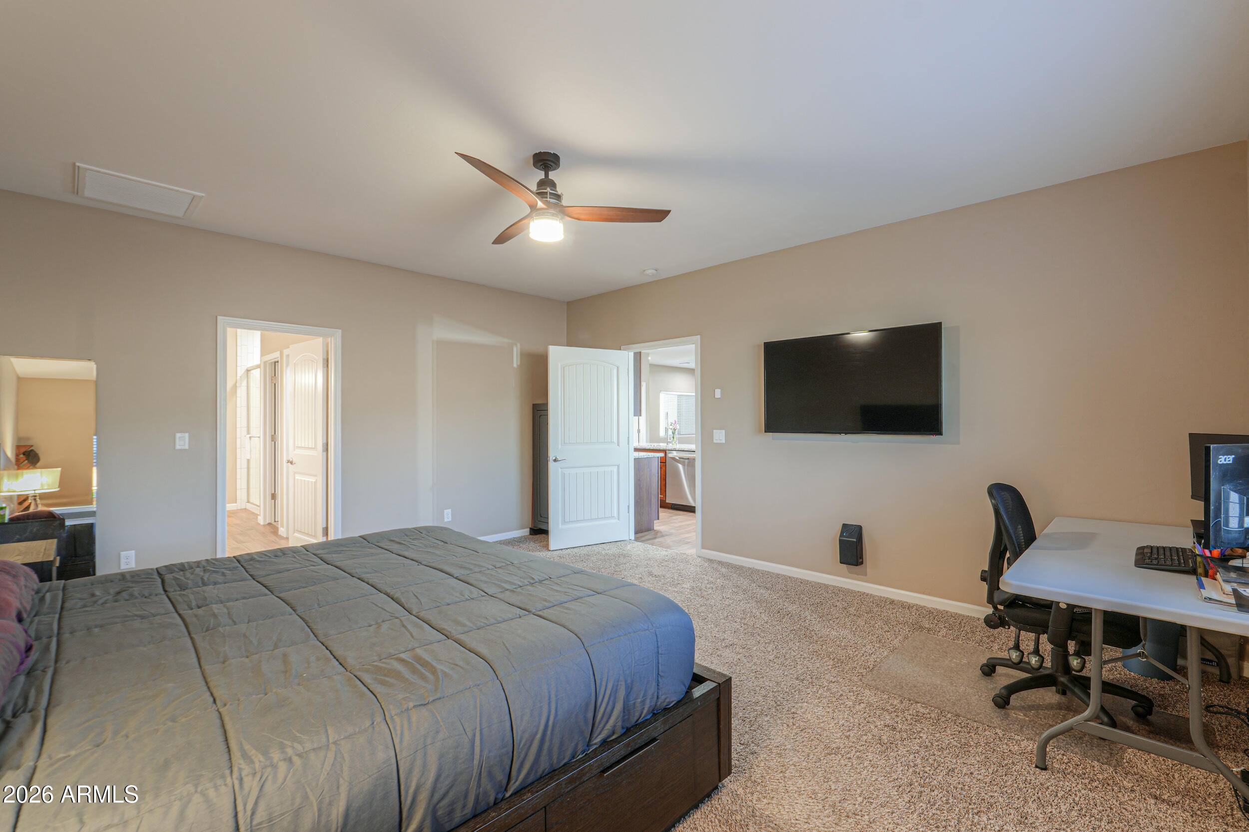 1487 South Mountain View Road Apache Junction, AZ 85119 - Photo 19 of 60 a spacious bedroom with a bed and a flat screen tv
