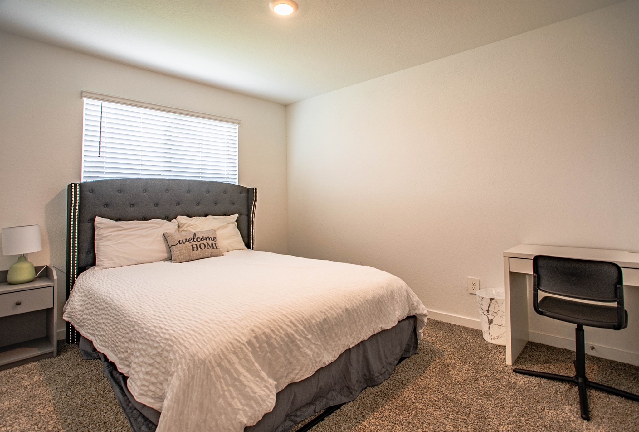 31810 Whittis Hill Way Fulshear, TX 77441 - Photo 13 of 23 This secondary bedroom at the front of the home offers a bright and welcoming space, ideal for guests or a home office. The room features plush carpeting, a large window that fills the room with natural light, and a neutral palette that’s easy to personalize. A cozy desk nook and stylish headboard add both comfort and function.