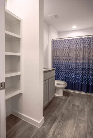 a bathroom with a toilet and a shower