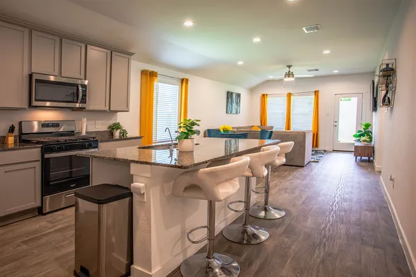 a large kitchen with lots of counter space a sink and appliances