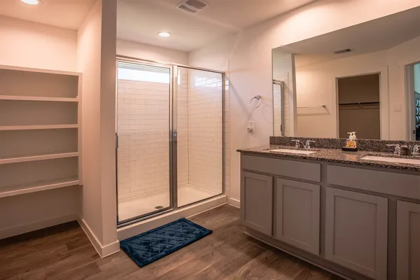 a bathroom with a double vanity sink and a mirror
