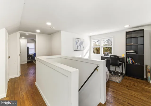 a view of a living room a dining room wooden floor and a window