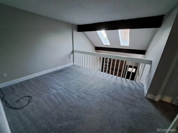 a view of an empty room with closet area