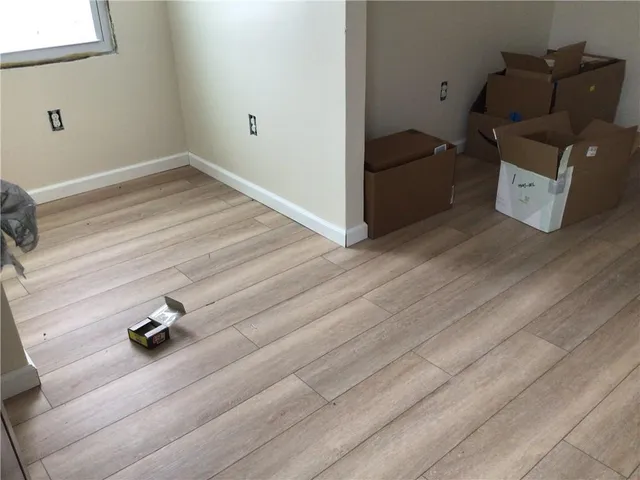 a view of storage and utility room with wooden floor