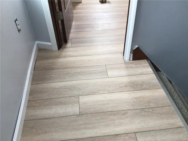 a view of staircase with white walls and railing