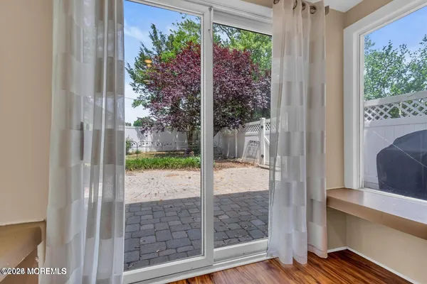 a bedroom with a large bed and windows