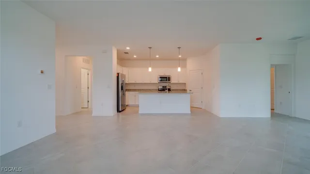 a view of a kitchen with a sink and a refrigerator