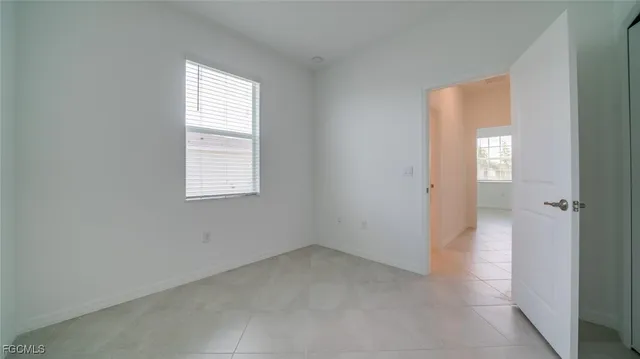 an empty room with windows and closet