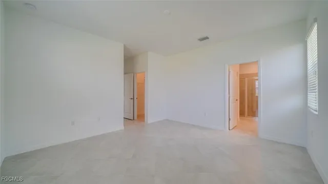 a view of an empty room and a window