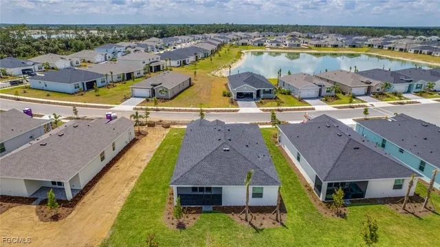an aerial view of residential houses with outdoor space and swimming pool