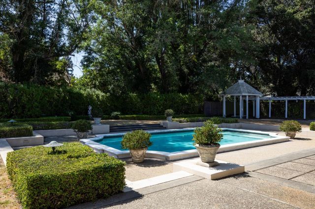a view of a house with backyard and sitting area