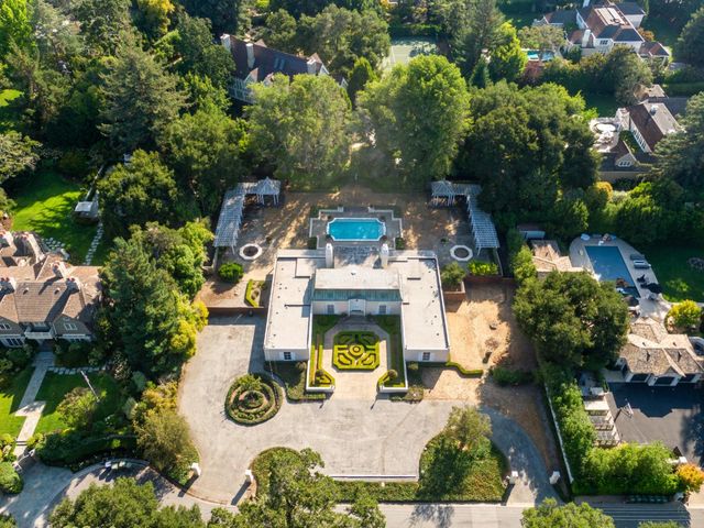 an aerial view of a house with yard swimming pool and outdoor seating