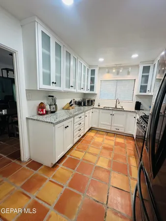 a kitchen with stainless steel appliances granite countertop a sink and cabinets