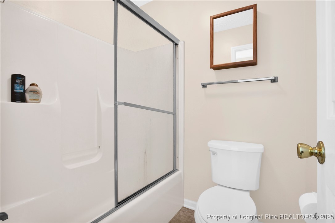 101 2 Hours Court Raeford, NC 28376 - Photo 23 of 30 a white toilet sitting next to a bathroom sink