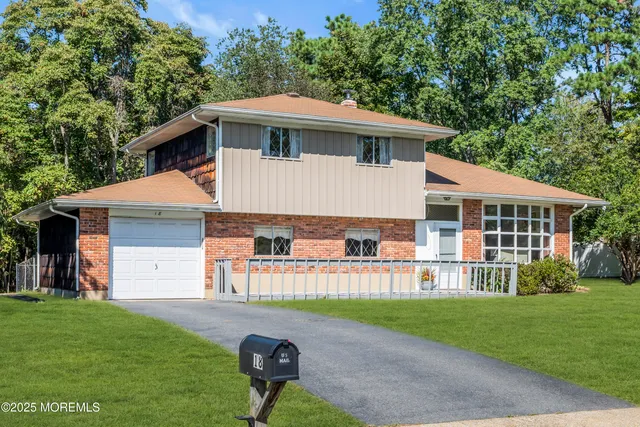 a view of a house with a yard and sitting area
