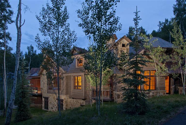 a view of a house with a tree and a yard