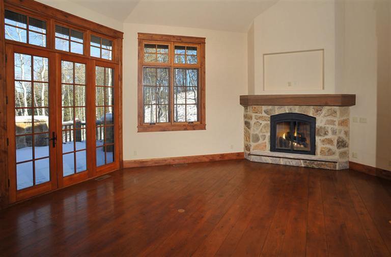 50 Elk Spring Court Edwards, CO 81632 - Photo 8 of 25 wooden floor fireplace and windows in an empty room