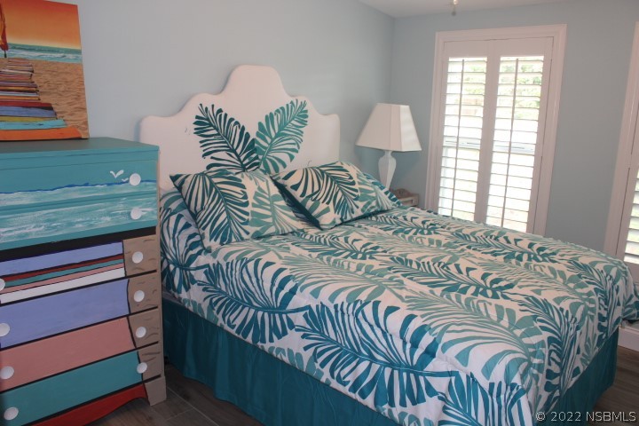 827 11th Avenue New Smyrna Beach, FL 32169 - Photo 11 of 21 a bedroom with a bed and a window
